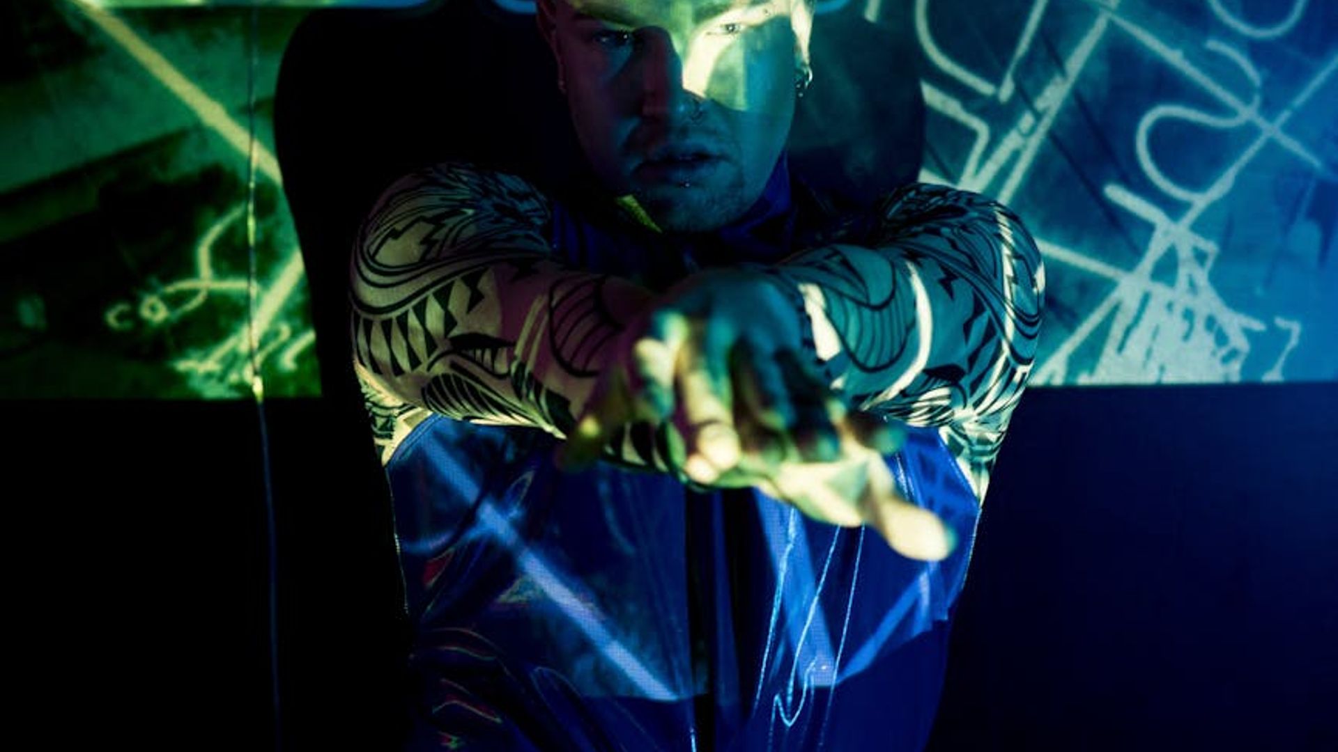 Active person moving in a dark studio with neon light accents.