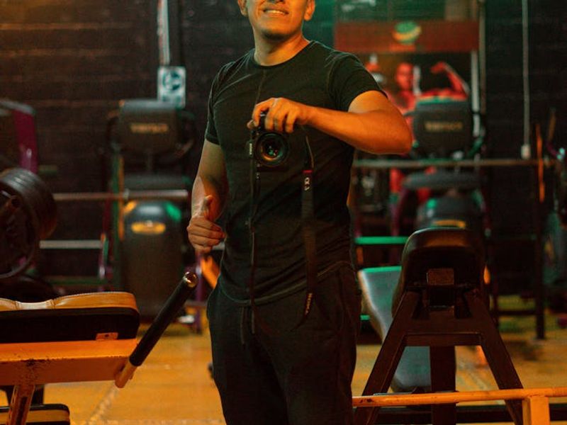 Dark fitness studio with neon lights and sports gear.
